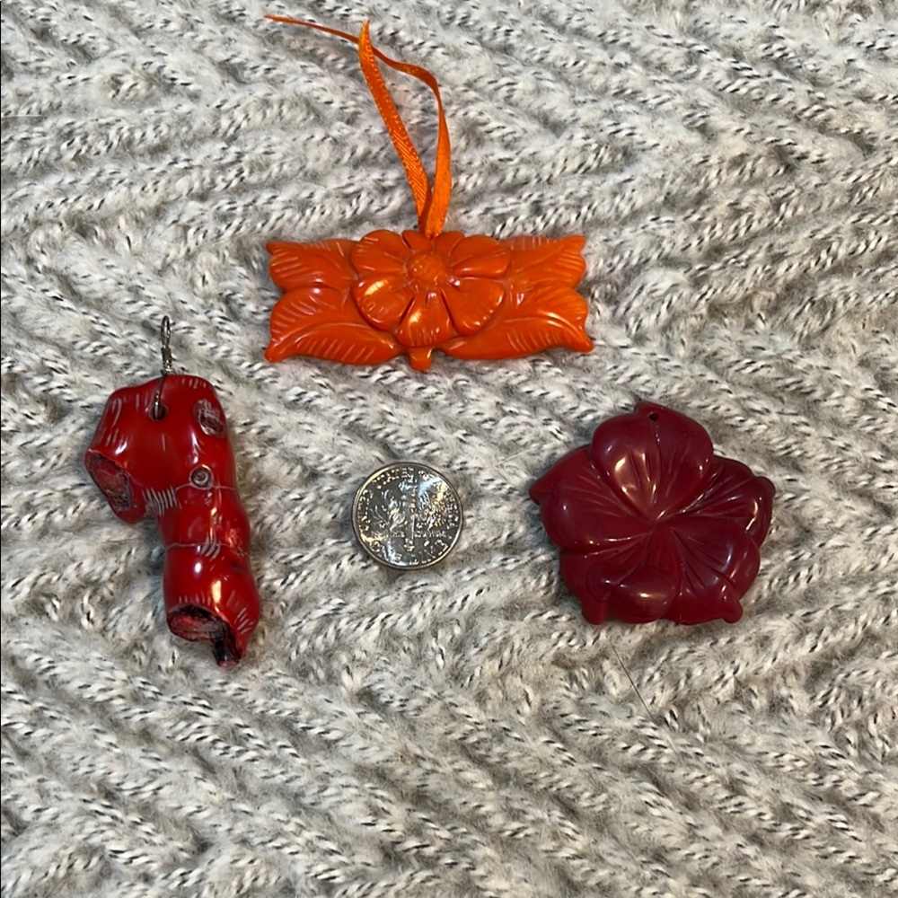 Carved stone and coral pendants